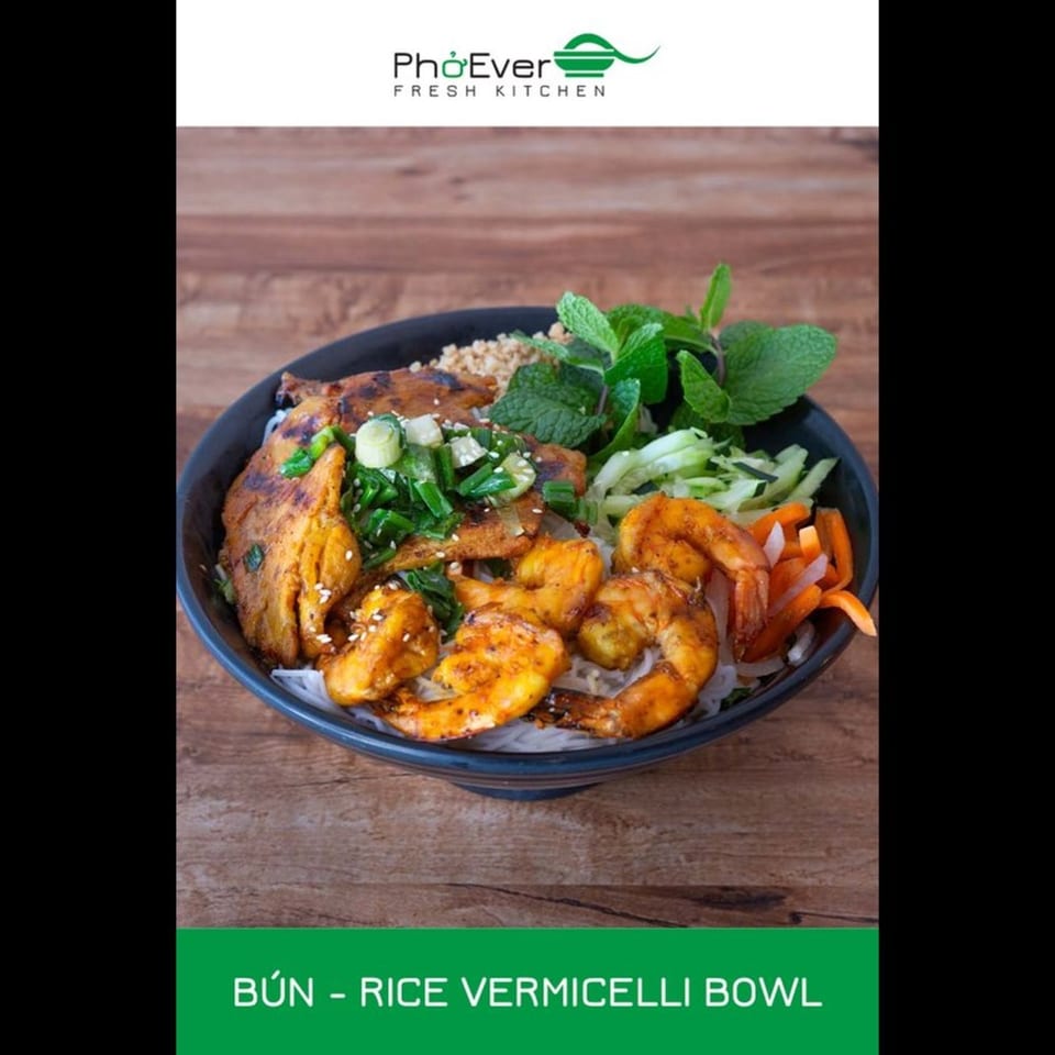 A PhoEver Fresh Kitchen Bún rice vermicelli bowl with shrimp, chicken, and fresh herbs.